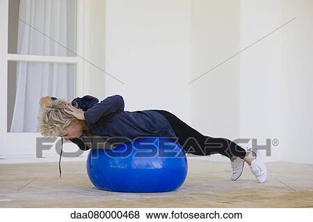 Mature woman doing pilates exercise on fitness ball View Large Photo Image Stock Photo - Mature woman doing pilates exercise on fitness ball. Fotosearch