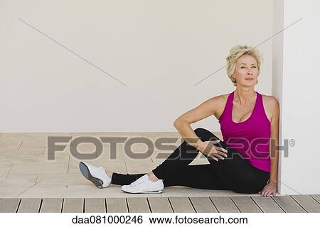 Mature woman doing spinal twist View Large Photo Image Stock Photograph - Mature woman doing spinal twist. Fotosearch