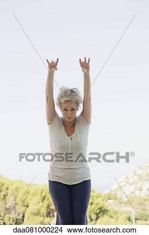 Mature woman doing sun salutation pose View Large Photo Image Picture - Mature woman doing sun salutation pose. Fotosearch
