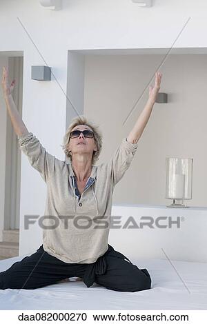 Mature woman exercising on bed outdoors View Large Photo Image Stock Image - Mature woman exercising on bed outdoors. Fotosearch
