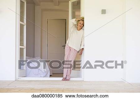 Mature woman in pajamas leaning against wall View Large Photo Image Stock Photography - Mature woman in pajamas leaning against wall. Fotosearch