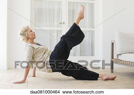Mature woman practicing pilates View Large Photo Image Picture - Mature woman practicing pilates. Fotosearch