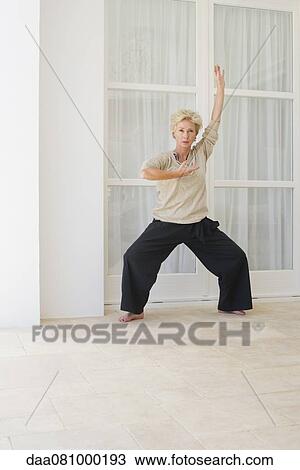 Mature woman practicing tai chi chuan View Large Photo Image Stock Image - Mature woman practicing tai chi chuan. Fotosearch