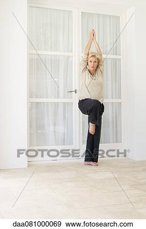 Mature woman practicing yoga View Large Photo Image Stock Photo - Mature woman practicing yoga. Fotosearch