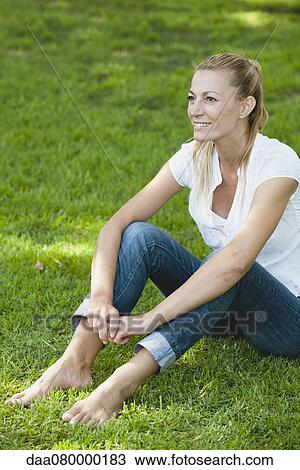 Mature woman relaxing on grass View Large Photo Image Stock Image - Mature woman relaxing on grass. Fotosearch