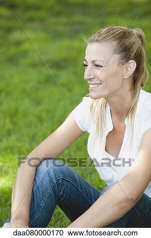Mature woman relaxing outdoors View Large Photo Image Stock Image - Mature woman relaxing outdoors. Fotosearch