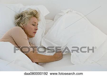 Mature woman sleeping in bed View Large Photo Image Stock Image - Mature woman sleeping in bed. Fotosearch