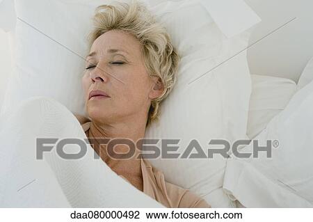 Mature woman sleeping in bed View Large Photo Image Stock Image - Mature woman sleeping in bed. Fotosearch