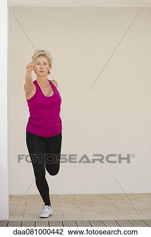 Stock Image - Mature woman stretching. Fotosearch