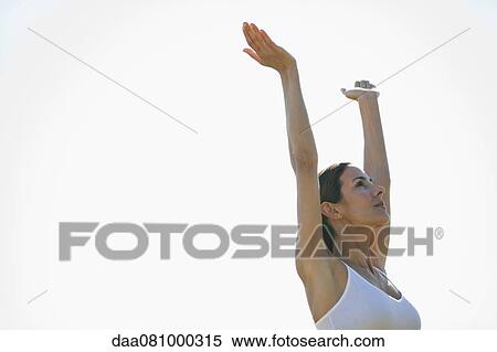Mid-adult woman doing sun salutation pose View Large Photo Image Stock Photography - Mid-adult woman doing sun salutation pose. Fotosearch