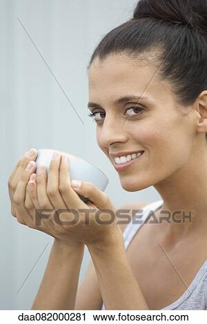Mid-adult woman holding bowl in cupped hands View Large Photo Image Stock Image - Mid-adult woman holding bowl in cupped hands. Fotosearch