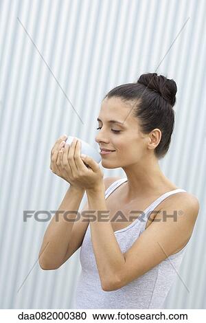 Mid-adult woman holding bowl in cupped hands View Large Photo Image Stock Image - Mid-adult woman holding bowl in cupped hands. Fotosearch