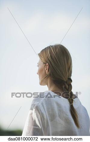 Mid-adult woman looking into distance View Large Photo Image Stock Image - Mid-adult woman looking into distance. Fotosearch