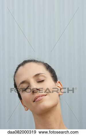 Mid-adult woman with eyes closed, smiling View Large Photo Image Stock Photo - Mid-adult woman with eyes closed, smiling. Fotosearch