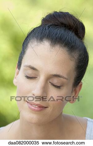Mid-adult woman with eyes closed, smiling View Large Photo Image Stock Photography - Mid-adult woman with eyes closed, smiling. Fotosearch