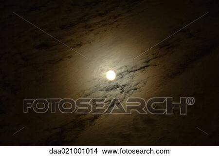 Moon in cloudy night sky View Large Photo Image Picture - Moon in cloudy night sky. Fotosearch