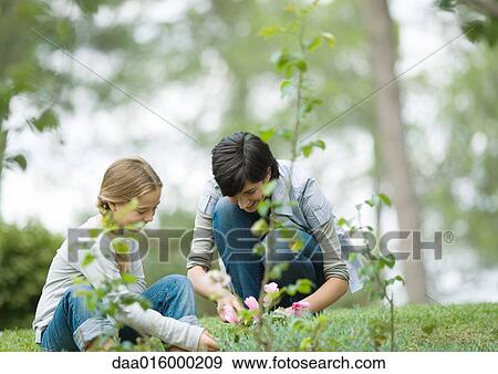 Mother and daughter doing yard work View Large Photo Image Stock Photo - Mother and daughter doing yard work. Fotosearch