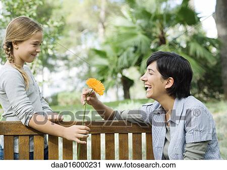 Mother and daughter, exchanging flower View Large Photo Image Stock Image - Mother and daughter, exchanging flower. Fotosearch