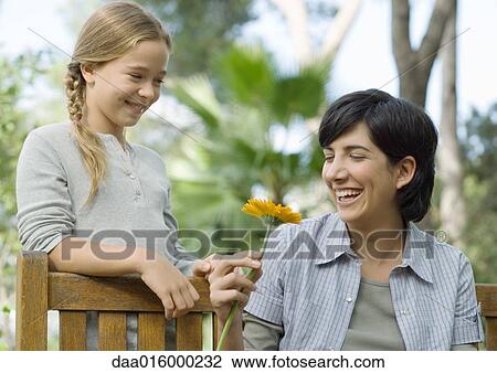 Mother and daughter, mother holding flower View Large Photo Image Stock Image - Mother and daughter, mother holding flower. Fotosearch