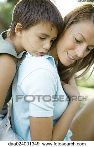 Mother and son, boy leaning head on woman's shoulder View Large Photo Image Stock Photo - Mother and son, boy leaning head on woman's shoulder. Fotosearch
