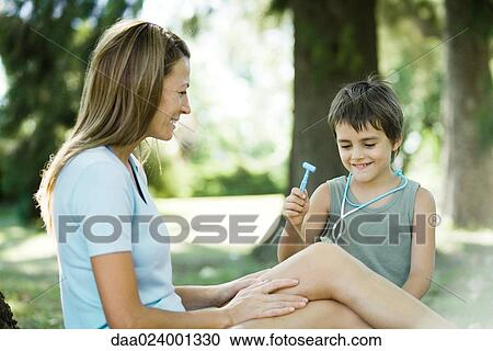 Mother and son, boy pretending to be doctor View Large Photo Image Stock Image - Mother and son, boy pretending to be doctor. Fotosearch