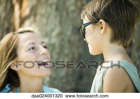 Mother and son, boy wearing sunglasses, woman laughing View Large Photo Image Stock Image - Mother and son, boy wearing sunglasses, woman laughing. Fotosearch