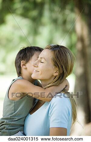Mother and son hugging, side view View Large Photo Image Stock Photography - Mother and son hugging, side view. Fotosearch