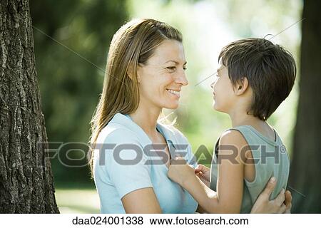Stock Photo - Mother and son outdoors, face to face. Fotosearch