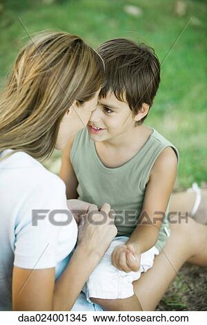 Mother and son sitting outdoors, playing together View Large Photo Image Stock Photography - Mother and son sitting outdoors, playing together. Fotosearch