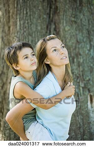 Mother and son, woman holding boy on back View Large Photo Image Stock Photo - Mother and son, woman holding boy on back. Fotosearch