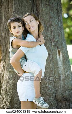 Mother and son, woman holding boy on back View Large Photo Image Stock Photo - Mother and son, woman holding boy on back. Fotosearch