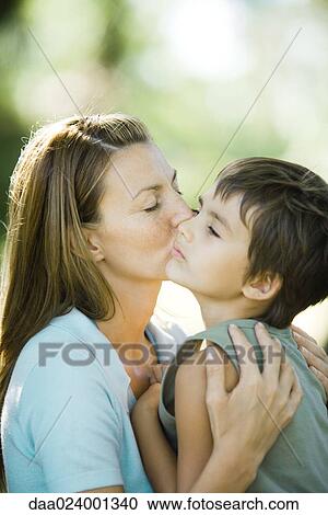 Mother and son, woman kissing boy on cheek View Large Photo Image Stock Image - Mother and son, woman kissing boy on cheek. Fotosearch