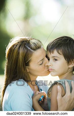 Mother and son, woman kissing boy on cheek View Large Photo Image Stock Photo - Mother and son, woman kissing boy on cheek. Fotosearch