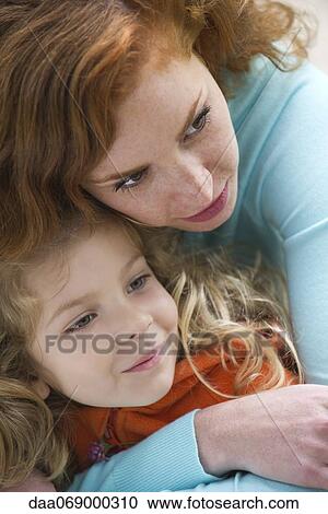 Mother embracing young daughter View Large Photo Image Stock Image - Mother embracing young daughter. Fotosearch