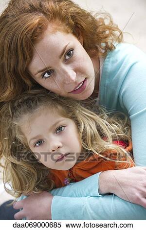 Mother embracing young daughter protectively View Large Photo Image Stock Photography - Mother embracing young daughter protectively. Fotosearch