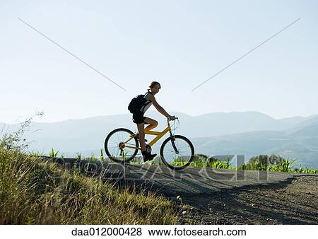 Mountain biker in mountainous landscape View Large Photo Image Stock Photo - Mountain biker in mountainous landscape. Fotosearch