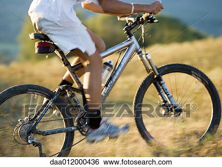 Stock Photograph - Mountain biker, low section. Fotosearch