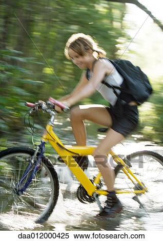 Mountain biker riding through water, motion View Large Photo Image Stock Photography - Mountain biker riding through water, motion. Fotosearch