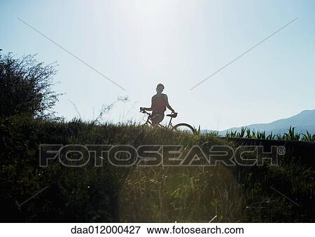 Stock Photo - Mountain biker, silhouette. Fotosearch