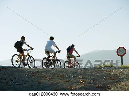Stock Image - Mountain bikers in mountainous landscape. Fotosearch