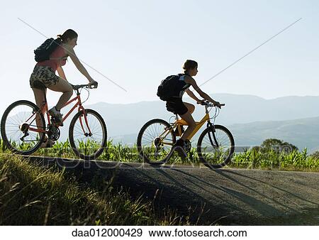 Mountain bikers in mountainous landscape View Large Photo Image Stock Photo - Mountain bikers in mountainous landscape. Fotosearch