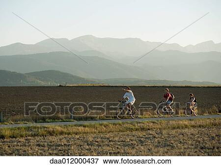 Stock Photo - Mountain bikers in mountainous landscape. Fotosearch