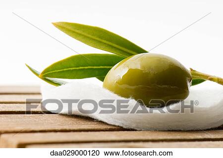 Stock Image - Olive on cotton cosmetic pad. Fotosearch