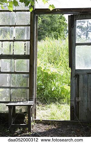 Stock Image - Open door of greenhouse. Fotosearch