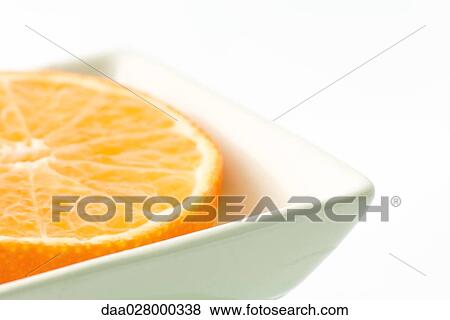 Orange half in small dish, close-up View Large Photo Image Stock Photo - Orange half in small dish, close-up. Fotosearch