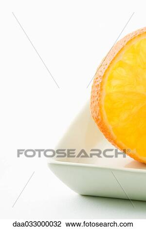 Orange slice in small dish, close-up View Large Photo Image Stock Image - Orange slice in small dish, close-up. Fotosearch
