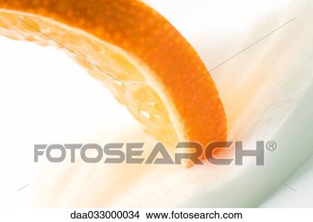 Orange slice on cotton cosmetic pad, close-up View Large Photo Image Picture - Orange slice on cotton cosmetic pad, close-up. Fotosearch