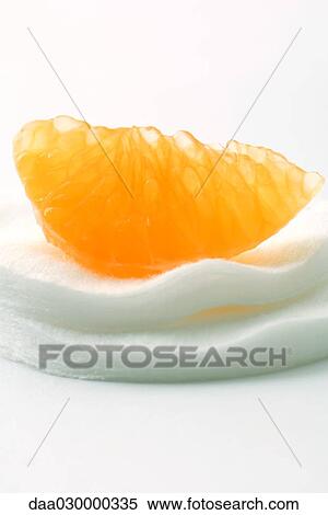Orange slice on cotton cosmetic pad, close-up View Large Photo Image Stock Photography - Orange slice on cotton cosmetic pad, close-up. Fotosearch