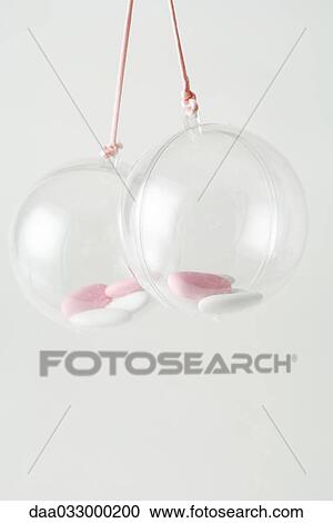 Pair of glass ornaments containing candy, close-up View Large Photo Image Stock Image - Pair of glass ornaments containing candy, close-up. Fotosearch