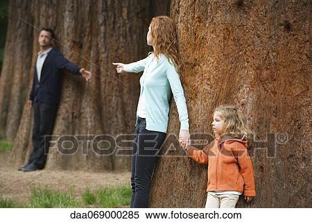 Parents leaning against separate trees, reaching out for each other View Large Photo Image Stock Photography - Parents leaning against separate trees, reaching out for each other. Fotosearch